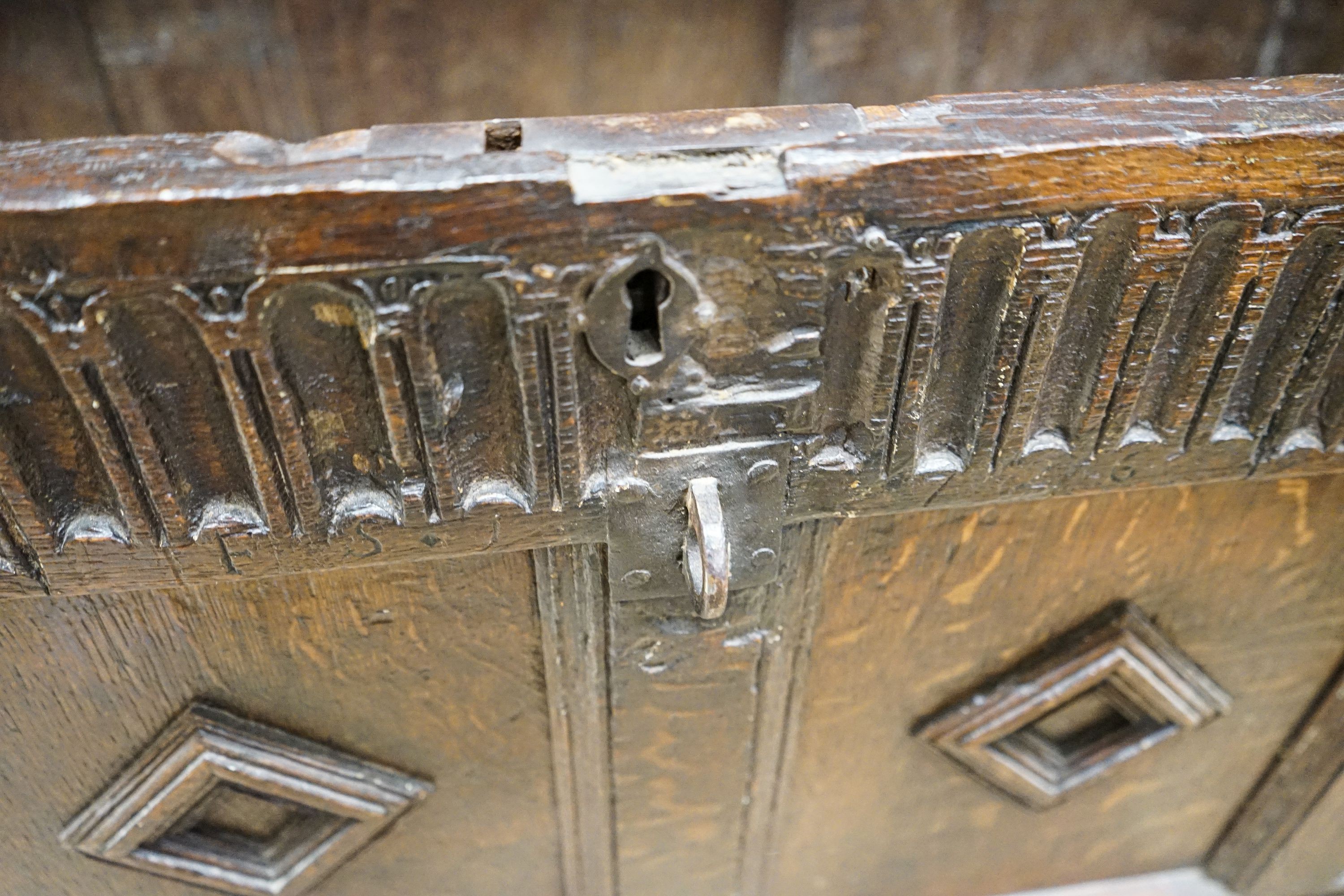 A late 17th century oak coffer, with four panel top and carved front, length 151cm, depth 58cm, height 69cm